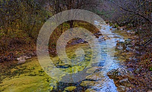 The bed of a mountain river Uzundzha flowing through the autumn reserved forest