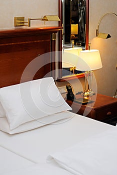 Bed and night table in a hotel room