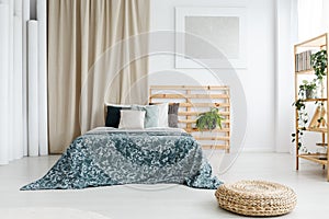 Bed with patterned blue coverlet photo
