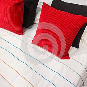 Bed with red and black velveteen cushions