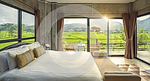 Bed room in hone stay in Nan with rice fields out sid of windows