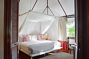 Bed room of a modern wooden house hotel in tropical country