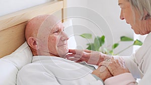 Bed, senior man and woman with love, care and support in sick, retirement and morning in home. Old couple, holding hands
