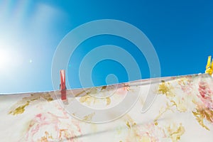 Bed sheet drying on a rope outside