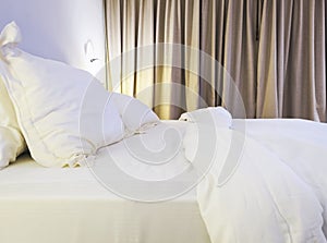 Bed sheet and pillow messed up in bedroom photo