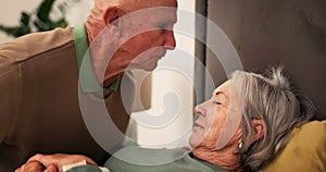 Bed, sick and senior couple kiss forehead for support, bonding and compassion together at home. Retirement, marriage and