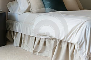 bed with a tailored cashmere bed skirt and highend sheets