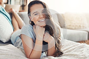 This bed is too comfortable. Portrait of an attractive young woman spending a relaxing day on her bed at home.