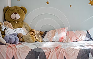 Bed with toys in children`s bedroom photo