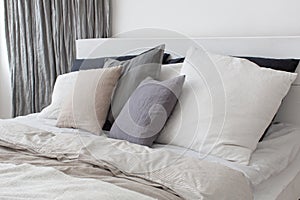 Bed with white and grey linens