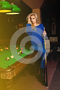 Beddable younge beauty woman posin at pool table