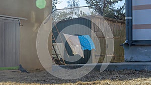 Bedding sheets drying on the clothesline outside. Lens flare. Bed linen drying on a clothes line in the garden.