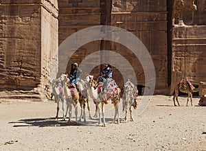 Bedouin guided on camels near Royal tombs. Petra. Jordan.