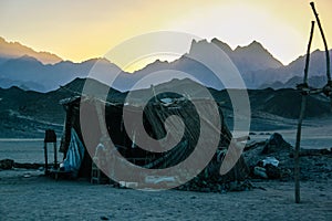 Bedouin hut in the desert against the backdrop of the mountains at sunset. Hurghada, Egypt.