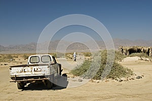 Bedouin man walking away from his truck.