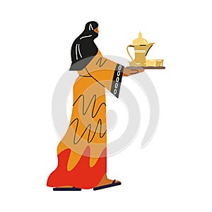 Bedouin woman with black scarf on head carries tray with dishes