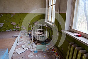 Bedroom in abandoned kindergarten in destroyed village Kopachi exclusion zone of Chernobyl Nuclear Power Plant, Ukraine