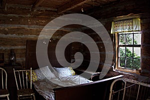 Bedroom in antique historic log cabin