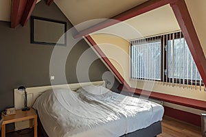 Bedroom in the attic, cosy double room in hotel, interior design