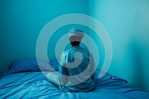 bedroom with azure walls, person wearing cerulean pajamas on skyblue bedding photo