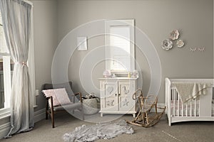 Bedroom of a baby with light-colored furniture and walls