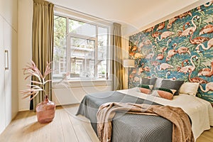 a bedroom with a bed and a colorful wallpaper on