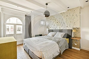 a bedroom with a bed and floral wallpaper