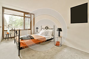 a bedroom with a bed and a large window