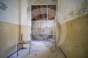 bedroom with bed and wardrobe in old abandoned house