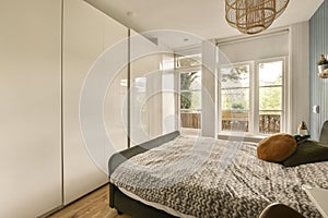 a bedroom with a bed and white closets