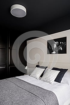 Bedroom with black ceiling and wardrobe