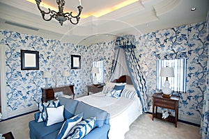 Bedroom with blue flower wallpaper