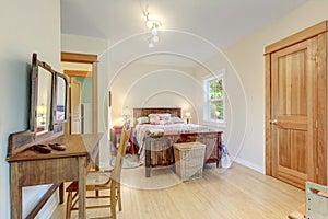 Bedroom bright interior with wooden bed and mirror with chair, country style of American cozy home with light bamboo flooring