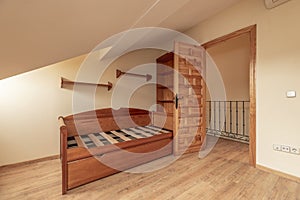 Bedroom with Castilian wood decoration, youth bed without mattresses and sloping ceilings