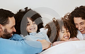 Bedroom, children and parents laughing, relax and bond with interracial kids, playful and enjoy funny weekend. Home bed