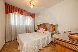 Bedroom with a double bed with a tacky wooden headboard