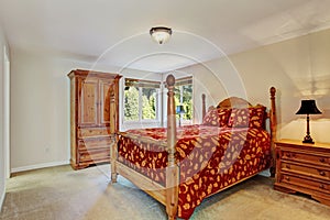 Bedroom with high pole bed and wardrobe