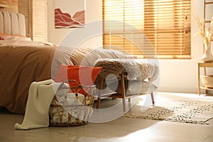 Bedroom interior with bed, basket and bench