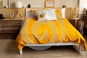 Bedroom interior bed in the interior, linen orange yellow bed linen . Lemon print