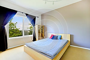 Bedroom interior with classic bed and bright purple curtains