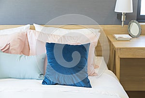 Bedroom interior with comfortable bed with pastel, blue and pink bedding