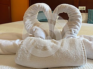 Bedroom interior design with swans from the towel decoration on bed