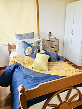 Bedroom interior design with yellow and blue as the main tone.