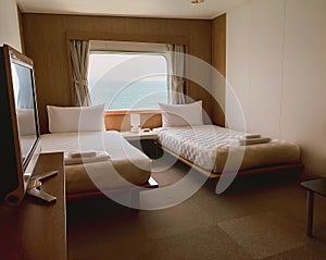 Bedroom with interior of double passenger cabin ferry ship with ocean view.