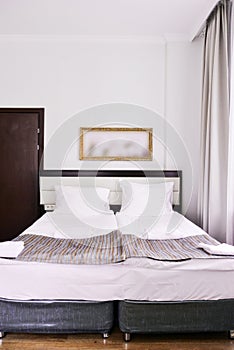 Bedroom interior in light colors, family bed. The concept of home comfort in the hotel.elegant classic