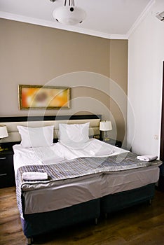 Bedroom interior in light colors, family bed. The concept of home comfort in the hotel.elegant classic