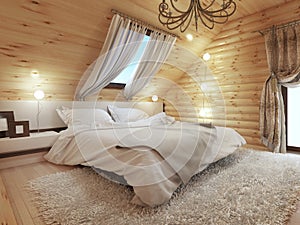 Bedroom interior in a log on the attic floor with a roof window.