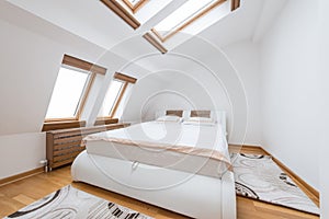 Bedroom interior in luxury loft, attic, apartment with roof wind