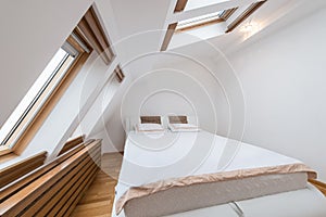 Bedroom interior in luxury loft, attic, apartment with roof wind