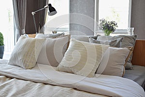 Bedroom interior with white striped pillows on bed